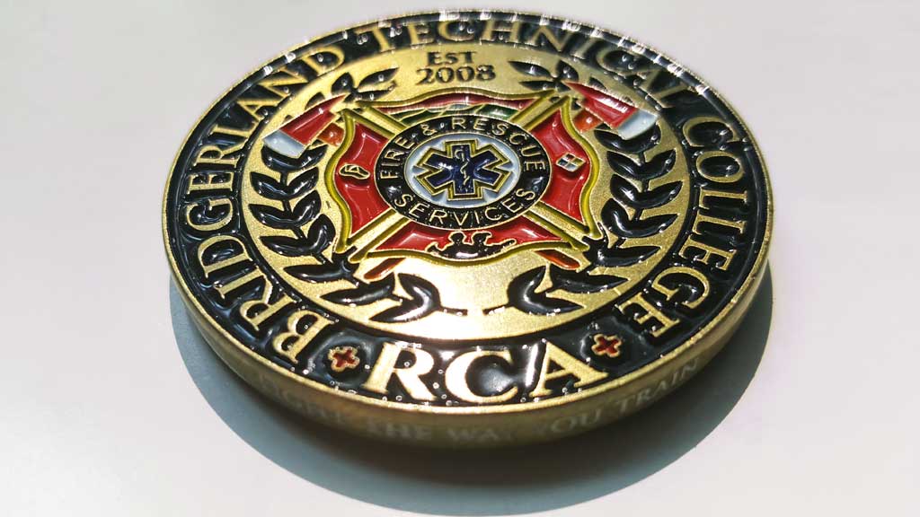 firefighter challenge coin front design showing the schools logo