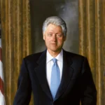 challenge coins behind former President Bill Clinton