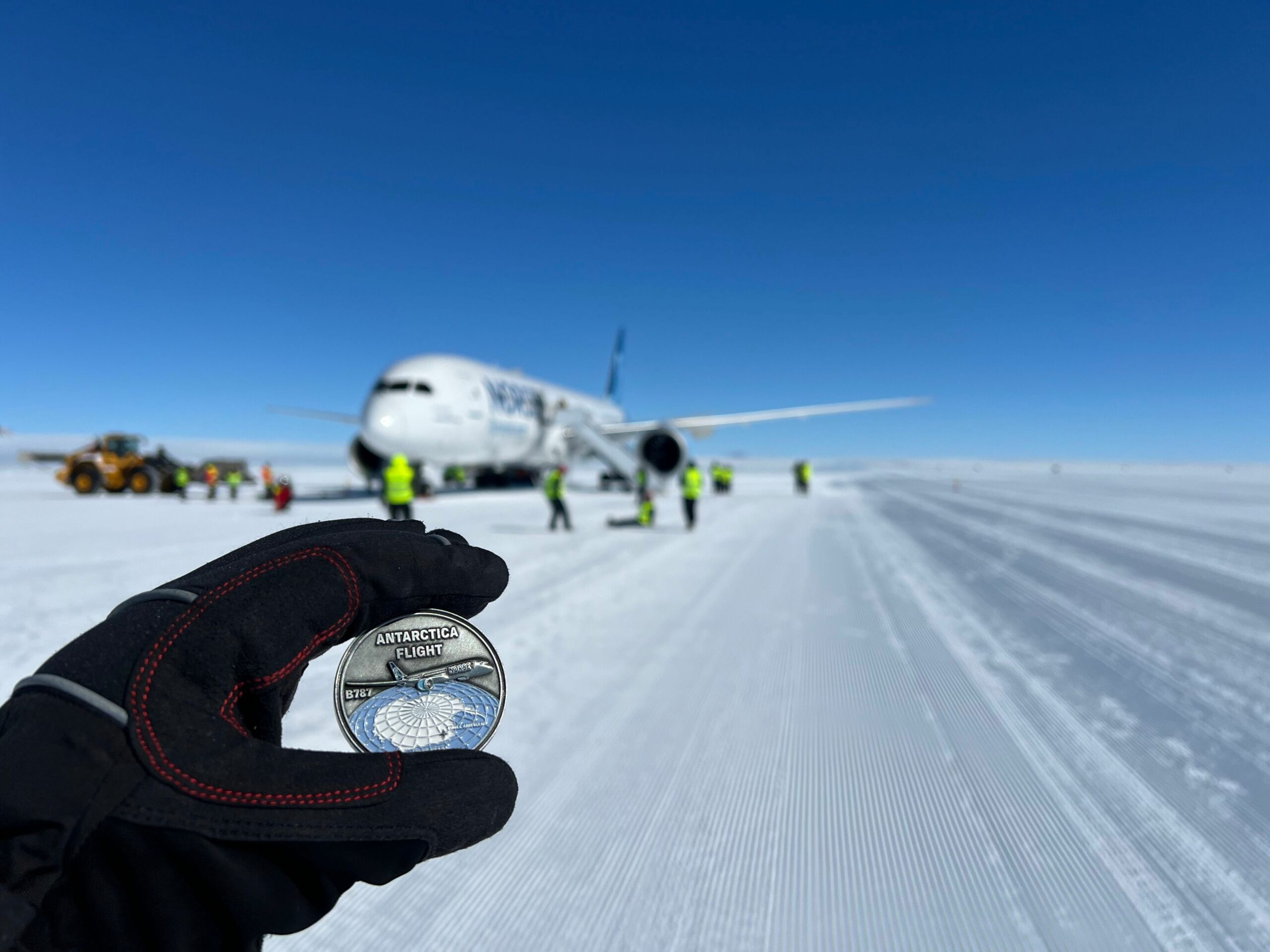 norse boeing 787 antarctica flight with custom challenge coin in foreground minted by Embleholics 