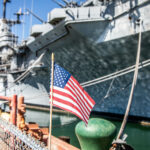 A selective focus shot of an American flag waving in the wind